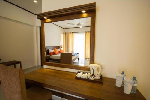 a living room with a large mirror on the wall at Okwin Resort Nawalapitiya in Kandy