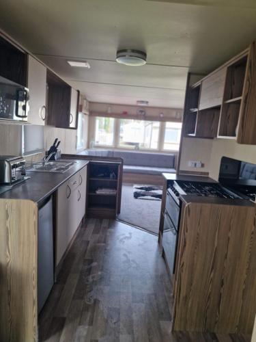 a kitchen with a sink and a stove at Haggerston Castle Towerlawn 50 in Cheswick