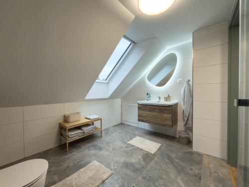 a bathroom with a toilet and a sink and a window at Chata na Lániku in Švošov