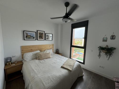 a bedroom with a bed and a ceiling fan at Golden view costa del sol in Torre del Mar