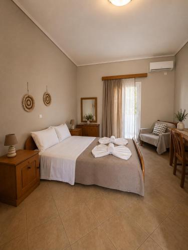 a bedroom with a bed with two towels on it at STUDIOS ATHENA in Megalochori