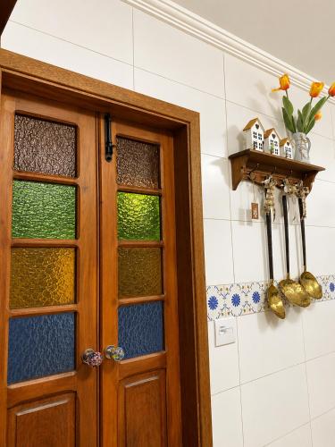 a door in a room with a tile wall at Casa Julieta in Serra Negra
