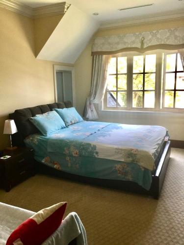 a bedroom with a large bed with a window at Vancouver lovely home in Vancouver