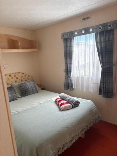 a bed with two pillows on it in a bedroom at Jay Valley Van in Flamborough