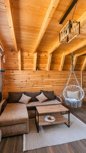 a living room with a couch and a table at Guest House Zabljak in Žabljak