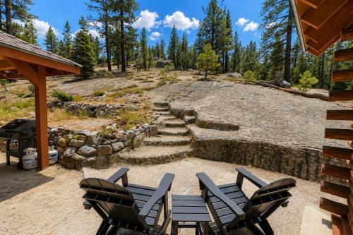 a patio with two chairs and a stone path at Twin Peaks Cabin in South Lake Tahoe