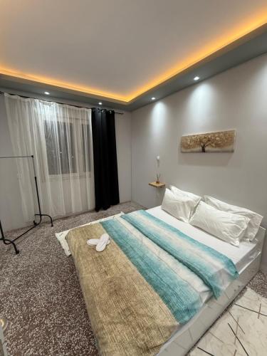 a bedroom with a large bed with a rug at Cozy Central Home with Balcony in Alexandroupoli