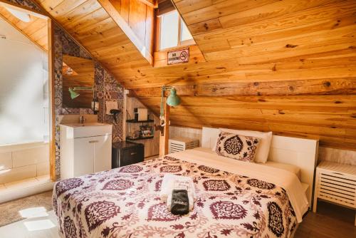 a bedroom with a bed in a room with wooden walls at Graça Guest House in Lisbon