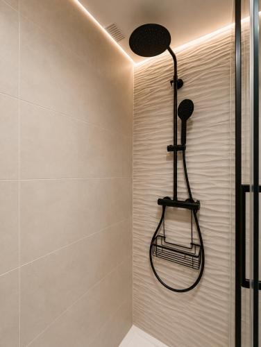 a bathroom with a shower with a towel rack at Apartamento Centro Granada-Ganivet in Granada