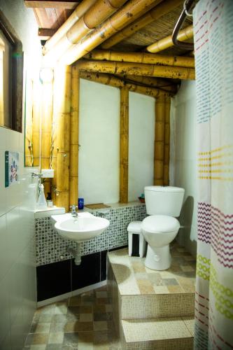 a bathroom with a toilet and a sink at Hospedaje La Tierrita Villa de Leyva in Villa de Leyva