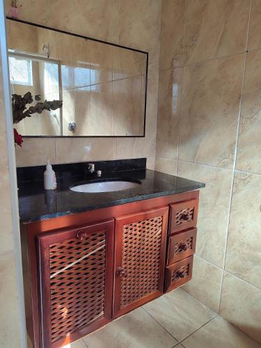 a bathroom with a sink and a mirror at Minha casa pousada in Botucatu
