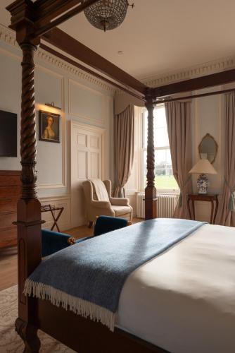 a bedroom with a large bed and a chair at The Townhouse, Leith in Edinburgh
