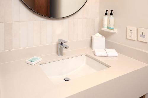 a white sink in a bathroom with a mirror at Hampton by Hilton Monterrey Tecnológico in Monterrey