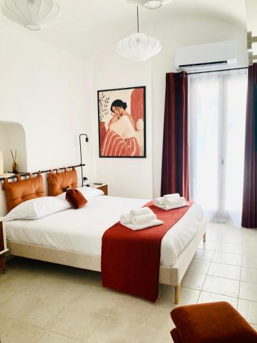 a bedroom with two beds and a large window at Antigua 22 in Monopoli
