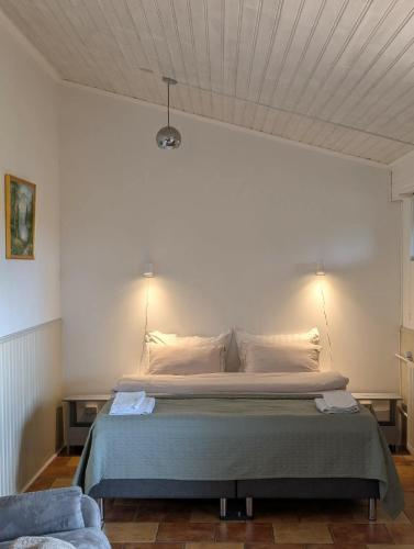 a bedroom with a large bed with two lamps at Studio apartment in countryside in Selfoss