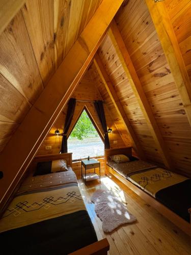 a room with two beds in a attic at Villa Komarnica Hideaway in Šavnik