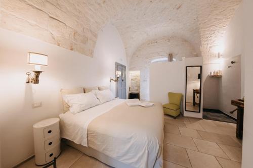 a bedroom with a large bed in a white room at Nobile Dimora di Puglia in Ostuni