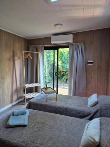 a bedroom with two beds and a window at Bio Espacio in Belén de Escobar
