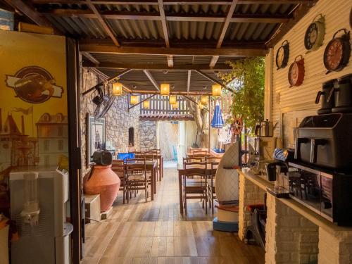 a restaurant with tables and chairs in a room at Tarihi Rum Konağı Antikhan in Ayvalık