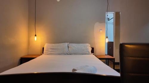 a bed with two pillows on it in a room at The Quiet Corner Guest House in Maputo