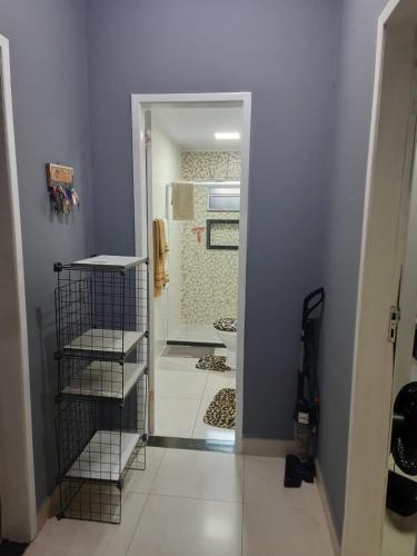 a bathroom with a walk in shower next to a door at Machado Monteiro in Guarapari
