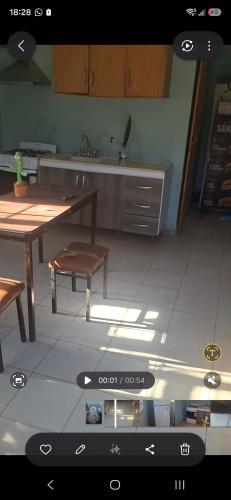 a view of a kitchen with a table and a bench at Francolini dptos in La Banda