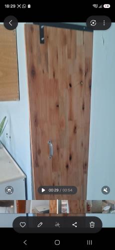 a wooden door in a kitchen with a counter at Francolini dptos in La Banda