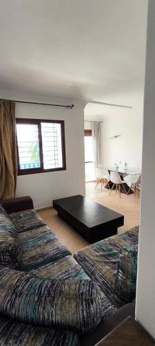 a bedroom with two beds and a table in it at kabila vista Z1 2 chambres in M'diq