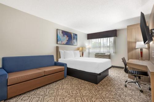 a hotel room with a bed and a couch at Best Western Airport Inn in Calgary