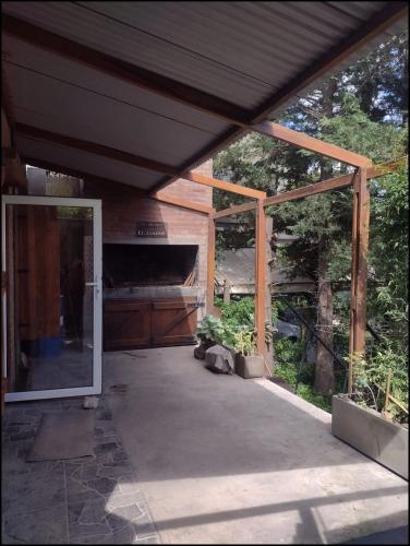 a screened in porch of a house with a sliding glass door at Lo de Adriana in Tandil