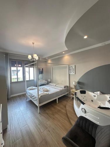 a large room with a bed and a bath tub at Dorian Gray Luxury Suite in Trieste
