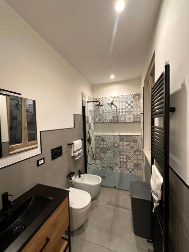 a bathroom with a sink and a toilet and a shower at Dorian Gray Luxury Suite in Trieste