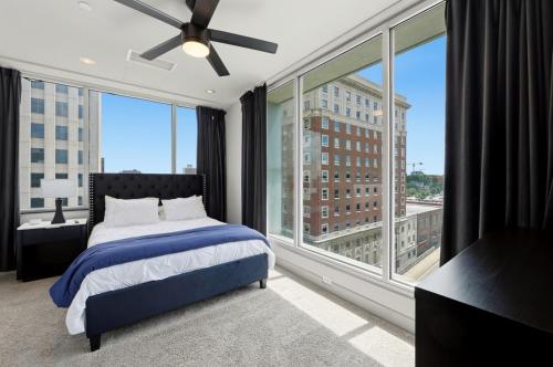 a bedroom with a bed and a large window at 175 LEX - Walkable Downtown Lexington & Rupp Arena - Full Condos in Lexington