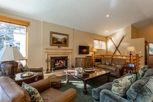 a living room with couches and a fireplace at Gore Creek Alpine Chalet in Vail
