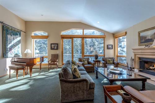 a living room filled with furniture and a fireplace at Gore Creek Alpine Chalet in Vail