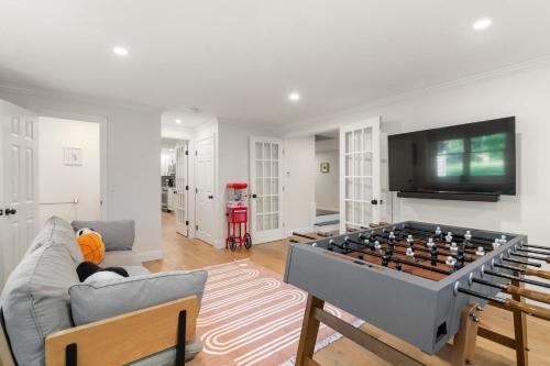 a living room with a large foosball table at Spacious Home with Private In-Ground Pool in Brewster