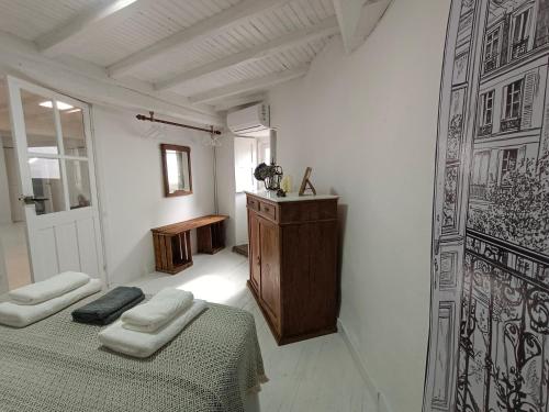 a bedroom with a bed and a table and a door at A Casiña do Río in Celanova