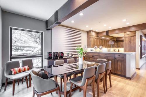 a kitchen and dining room with a table and chairs at Vail Ski-In Ski-Out Chalet in Vail