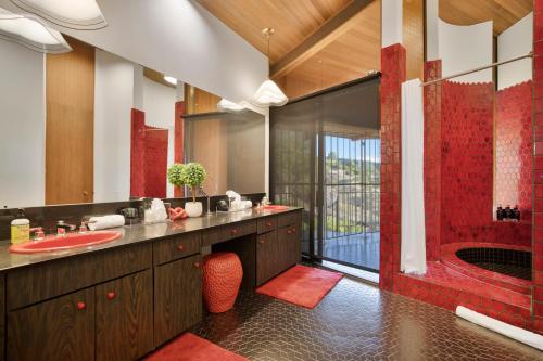 a bathroom with a red sink and a shower at Via Vallarta in Los Angeles