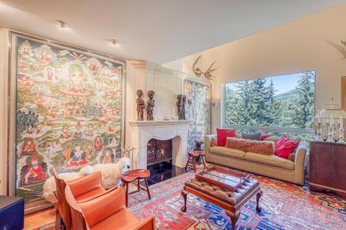 a living room with a large painting on the wall at Ski-in Ski-Out the View in Vail in Vail