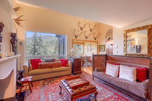 a living room with two couches and a mirror at Ski-in Ski-Out the View in Vail in Vail