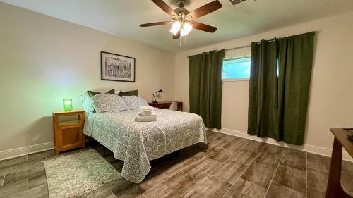 a bedroom with a bed and a ceiling fan at Sabana in Lake Charles