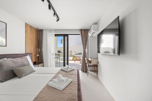 a hotel room with a bed and a balcony at Villa Olea Mandalina in Šibenik