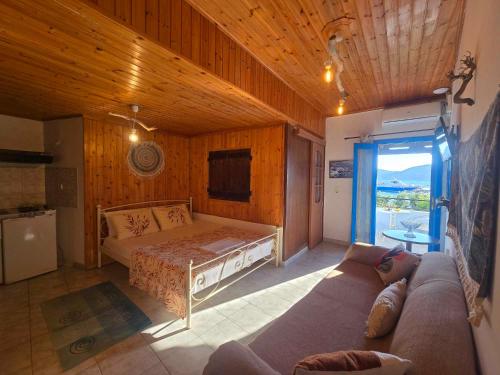 a living room with a bed and a couch at Agla Studio 2 in Fournoi