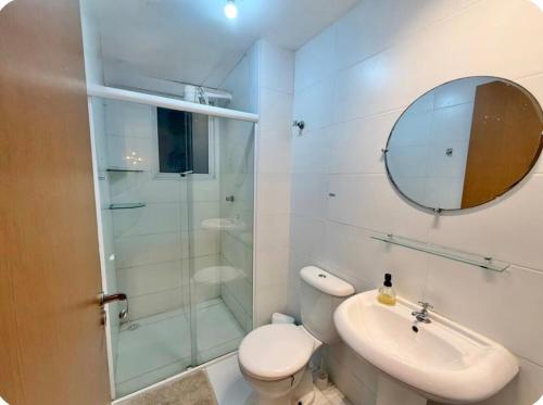 a bathroom with a shower and a toilet and a sink at Apto Com 2 Ar condicionados, Lava e seca, Wi-Fi in Caruaru