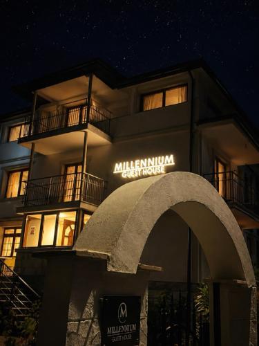 a building with an arch in front of it at night at Millennium Guest House in Kŭrdzhali