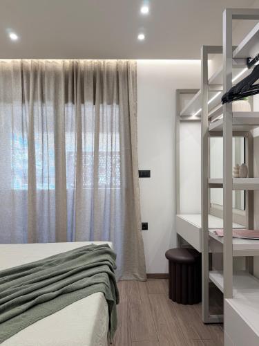 a bedroom with a bunk bed and a window at EROS & PATHOS Suites in Kremasti