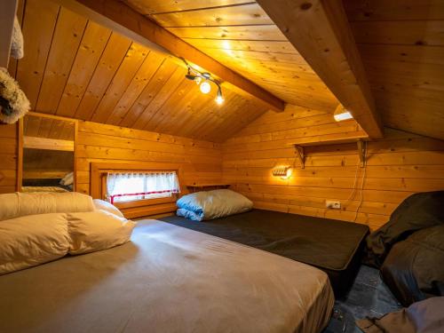 a room with two beds in a wooden cabin at Pauls-Hütte in Hippach