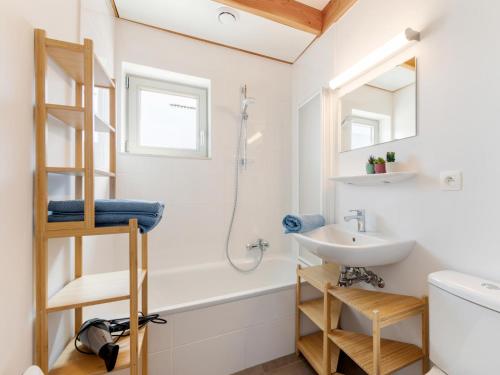a bathroom with a sink and a toilet and a shower at Westhinder II H14 in Koksijde
