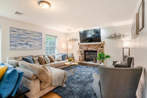 a living room with a couch and a fireplace at Golden Deer Lodge Hot Tub Sauna Sleeps 12 in Tobyhanna